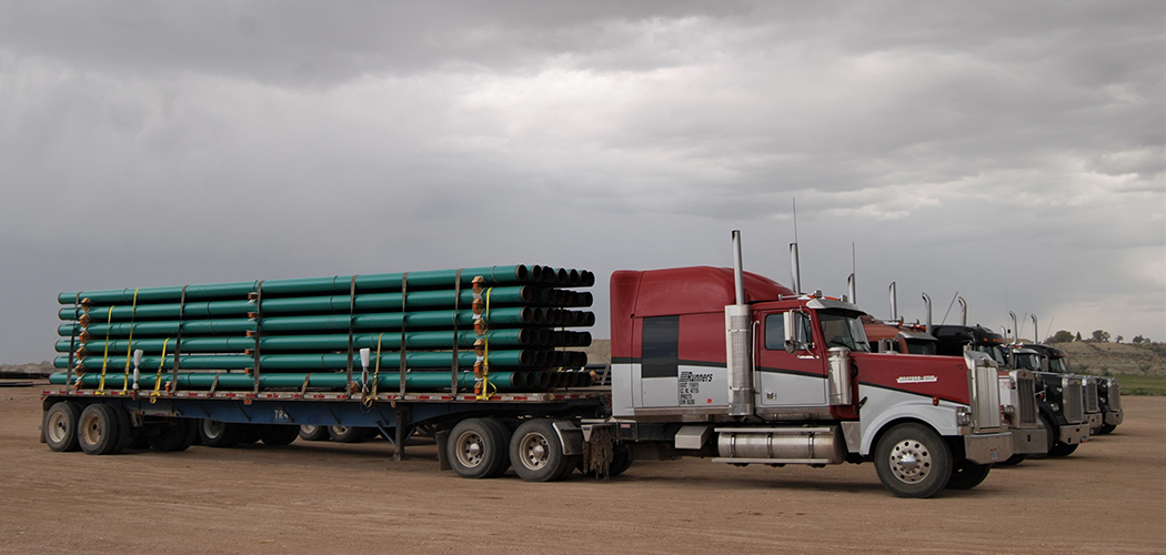 Semis with pipes on the bed lined up